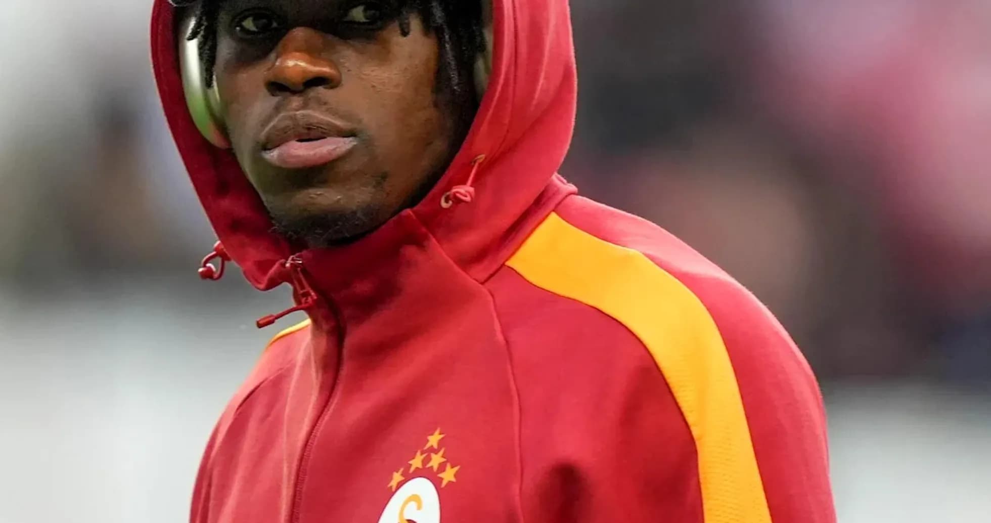 Player in Galatasaray hoodie during warm-up