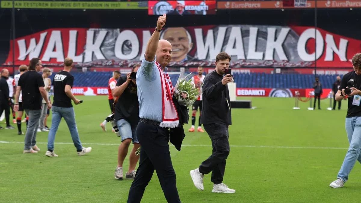 Man waving with flowers on the pitch post-match Man waving with flowers on the pitch post-match
