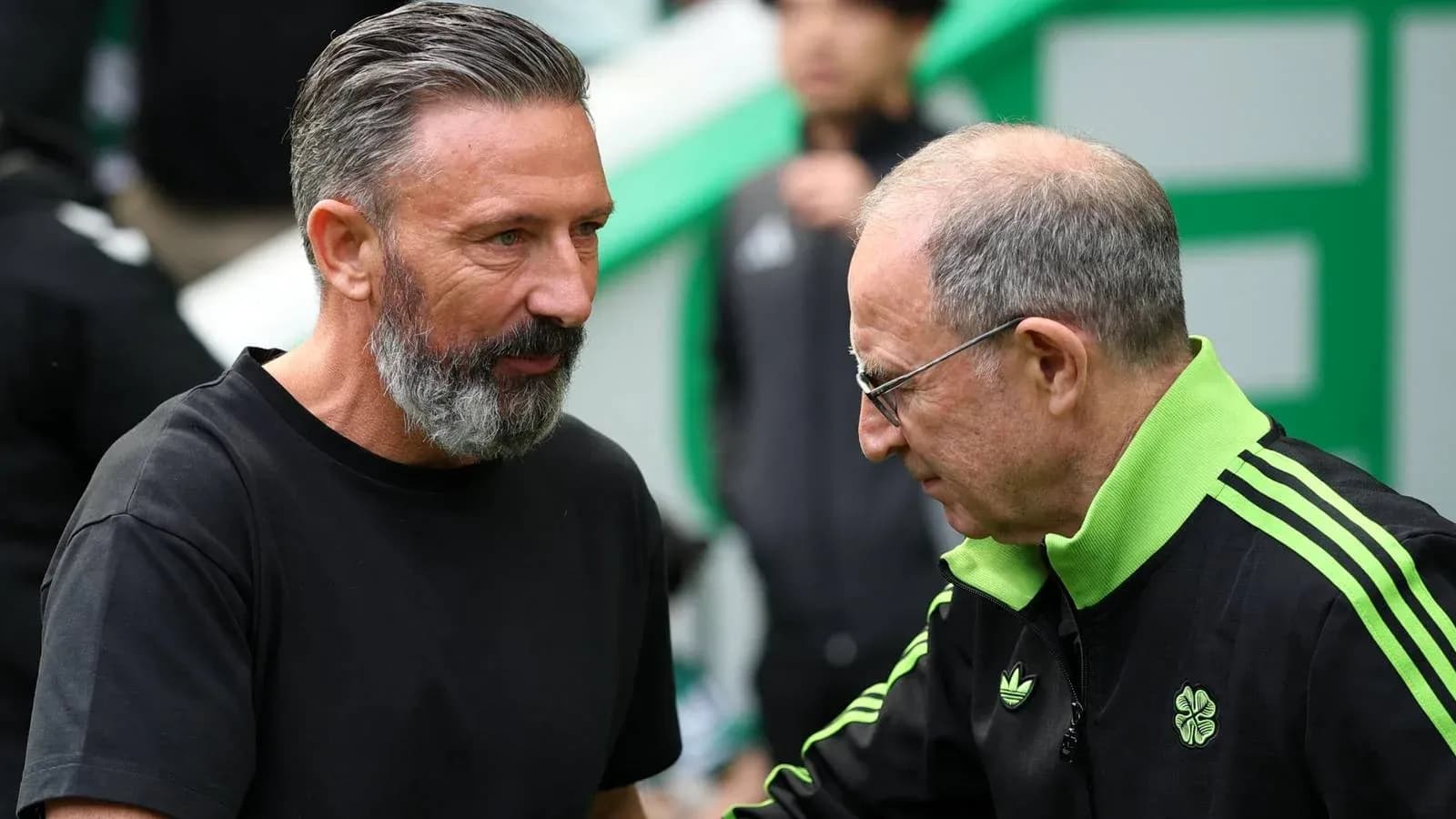 Two coaches discussing before a match