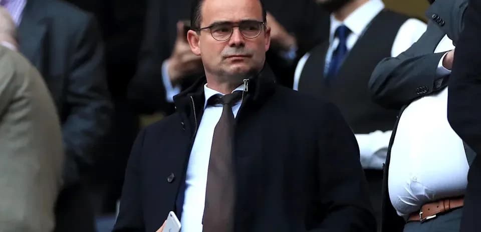 Man in suit observing from VIP section
