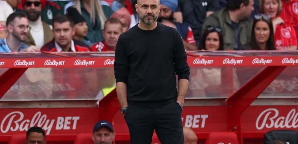 Coach standing on the sideline during match