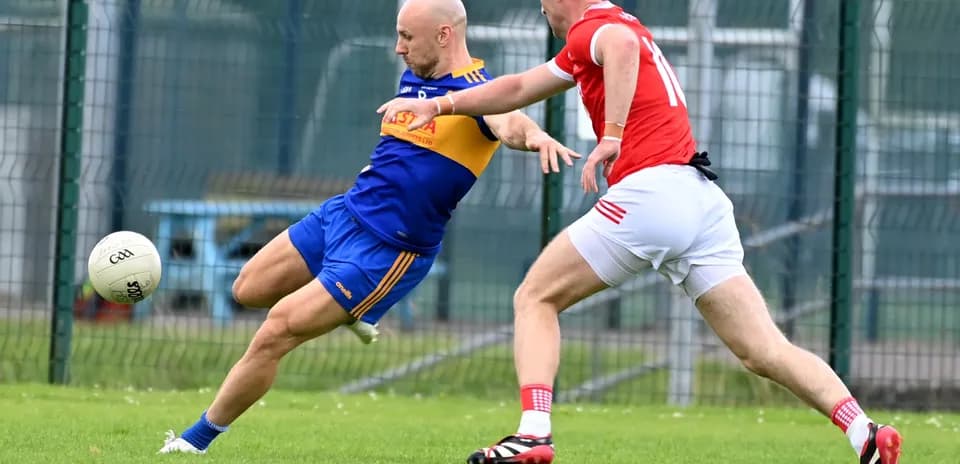 Player in blue tackling opponent in red during match