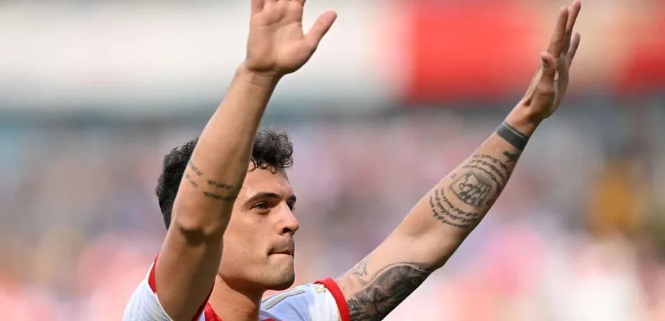 Player waving to fans during match celebration
