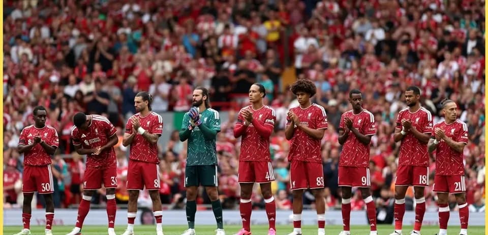 Liverpool players lined up, applauding fans at Anfield