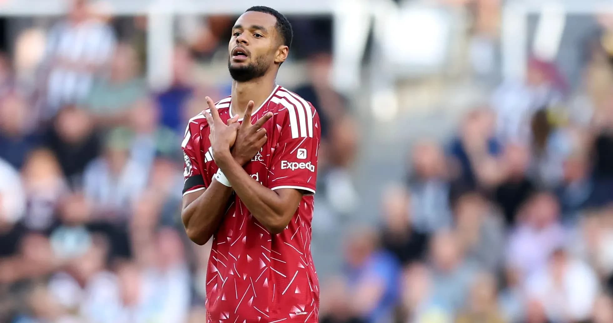 Player celebrating goal with hands raised on field
