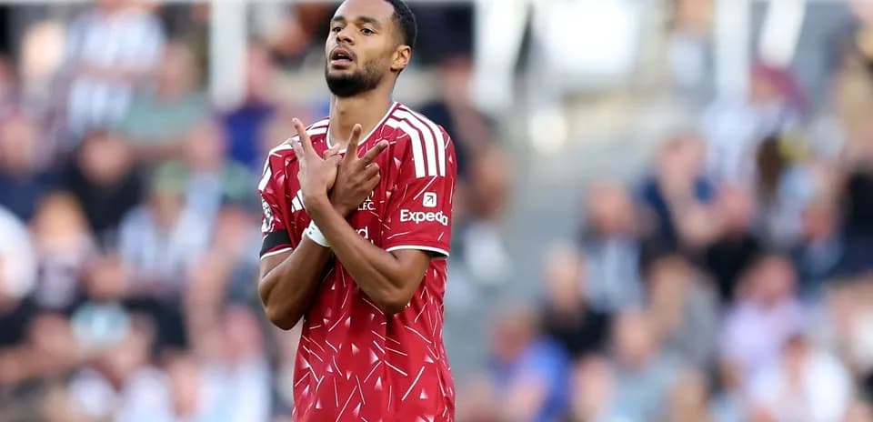 Player celebrating goal with hands raised on field