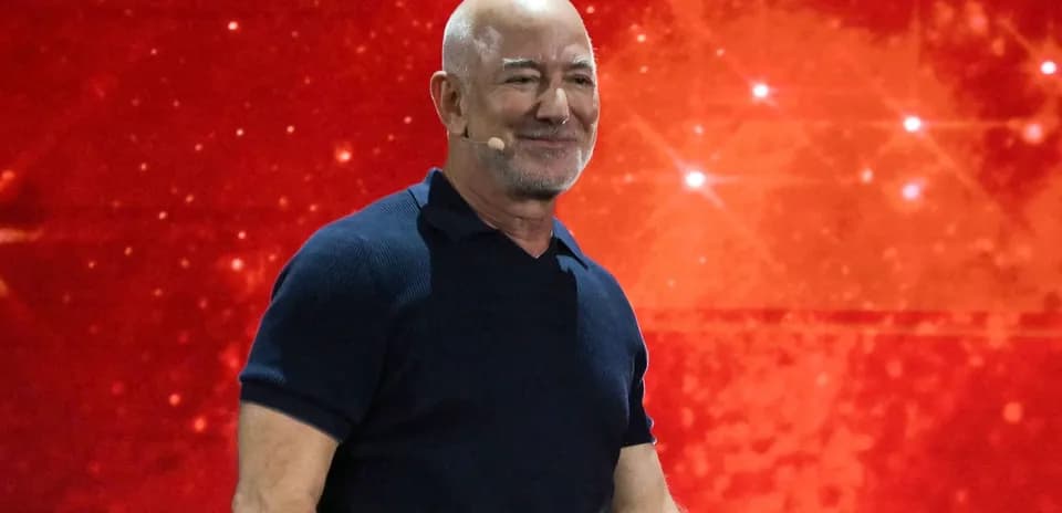 Speaker presenting on stage with red background
