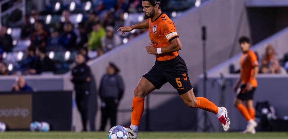 Player dribbling ball during New Mexico United match
