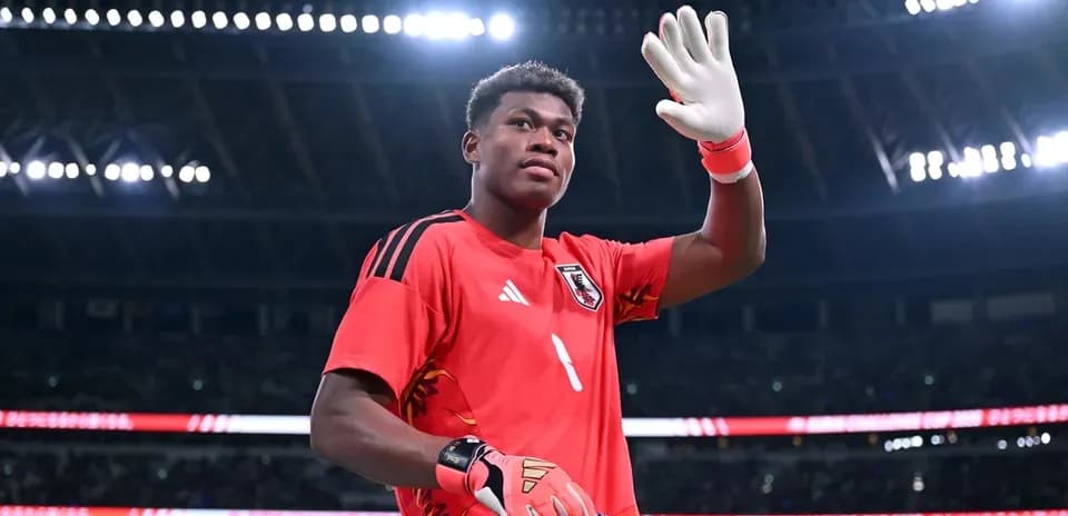 Goalkeeper waving while holding a team flag