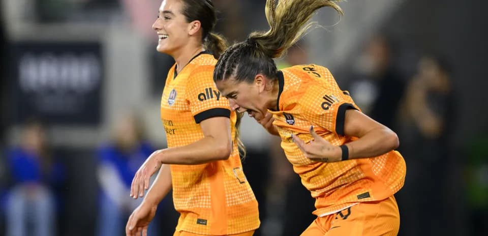 Players celebrating during NWSL match