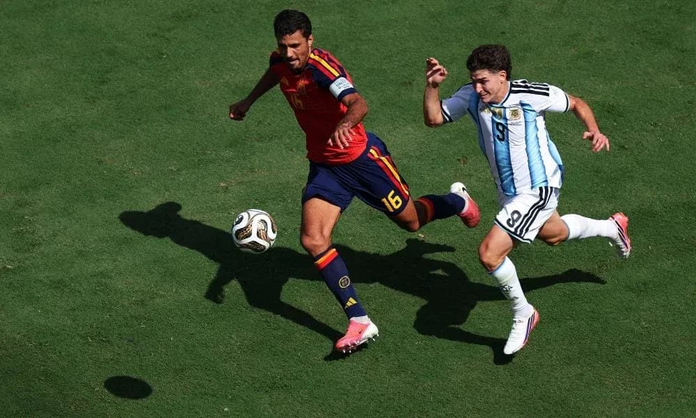 Two players competing for the ball on field