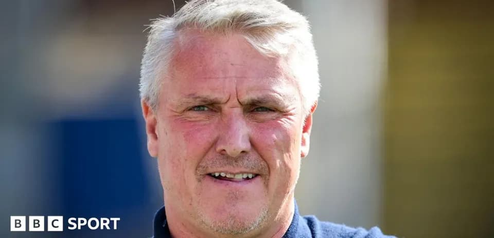 Man with short gray hair smiling at camera