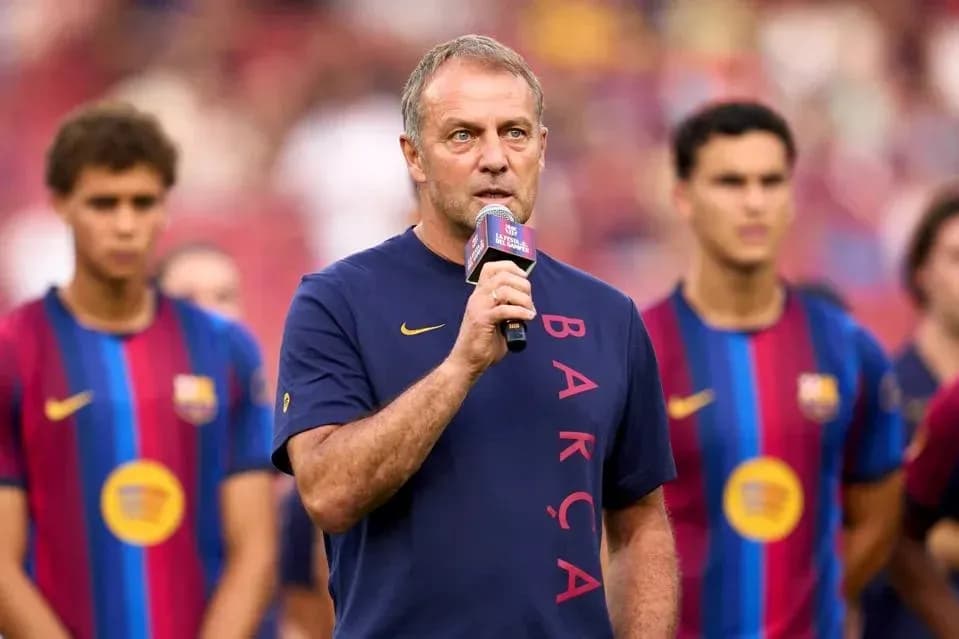 Coach speaking at event with players in background