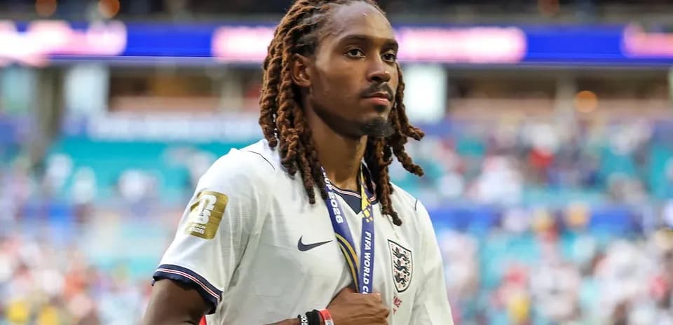 Player wearing England jersey walking on field