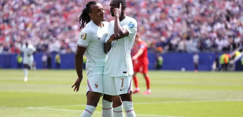 Two French players celebrating on the pitch