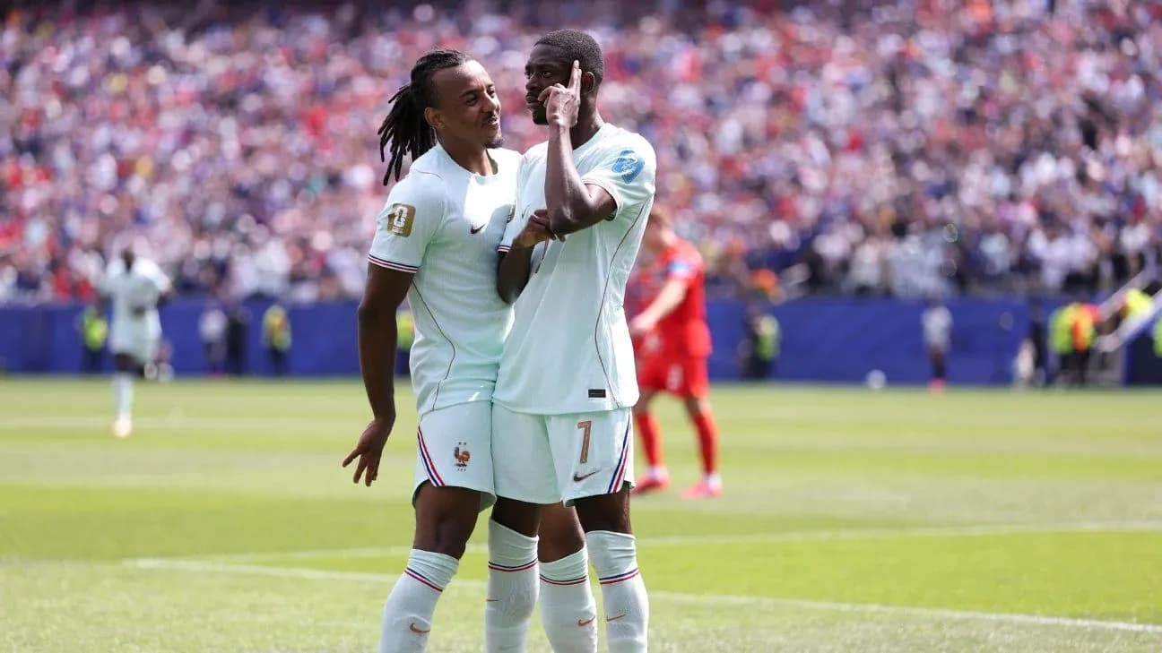 Two French players celebrating on the pitch