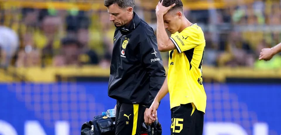 Player receiving assistance from staff after injury