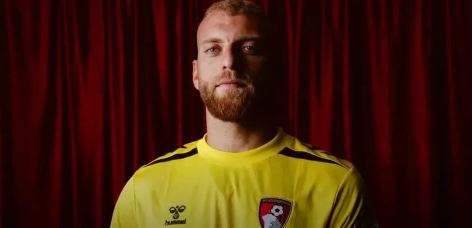 Goalkeeper wearing yellow jersey with AFC Bournemouth crest