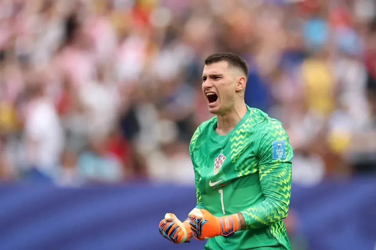 Goalkeeper celebrating during a match with crowd in background