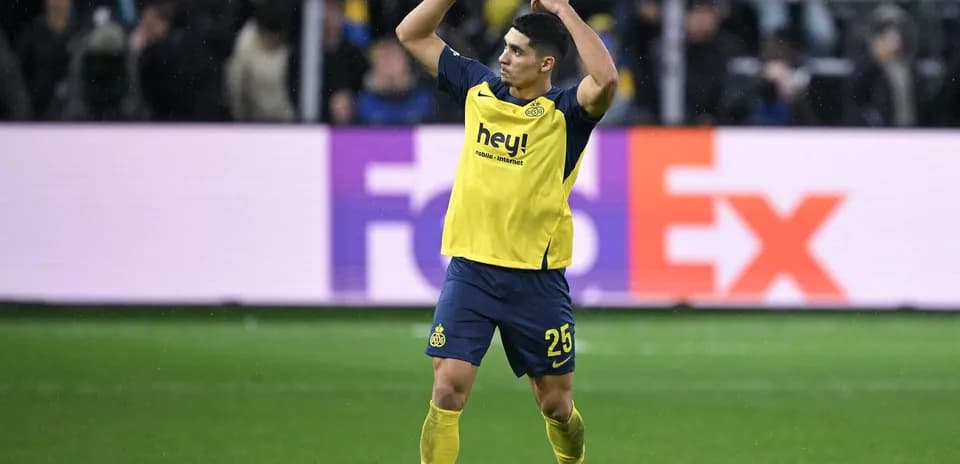Player celebrating on field wearing yellow jersey