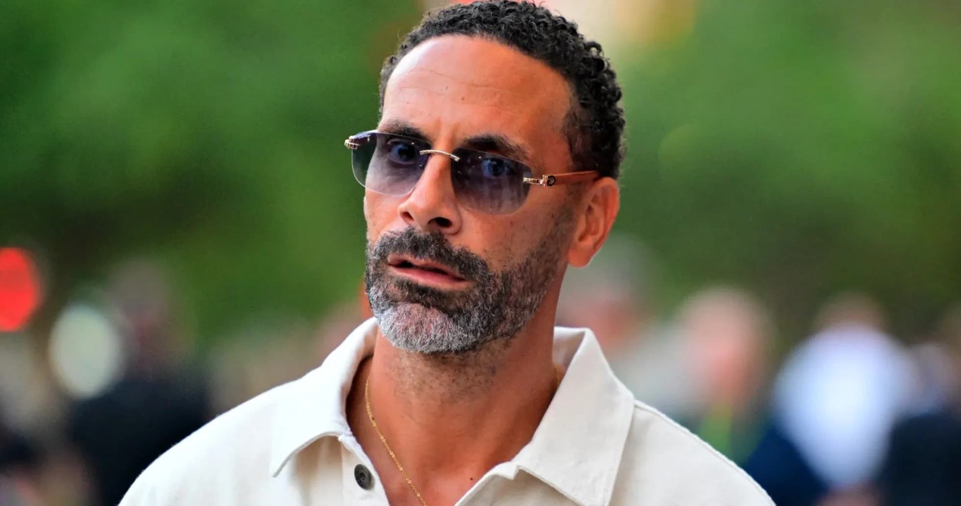 Man wearing sunglasses walking outdoors