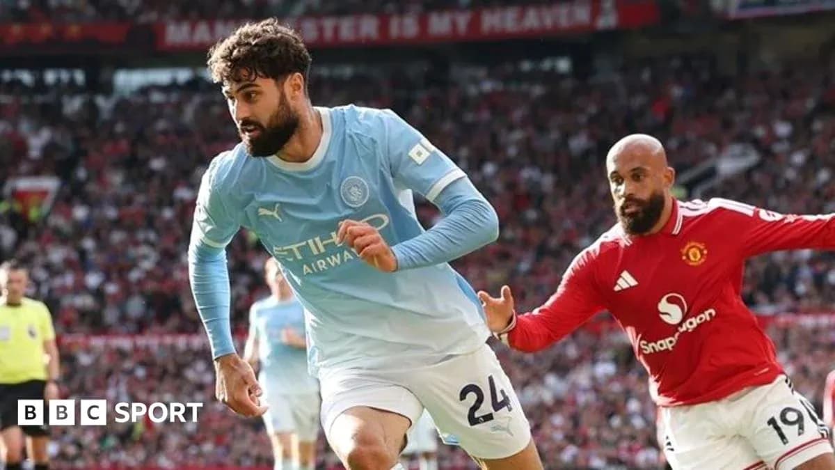 Manchester City player sprinting during match against Manchester United