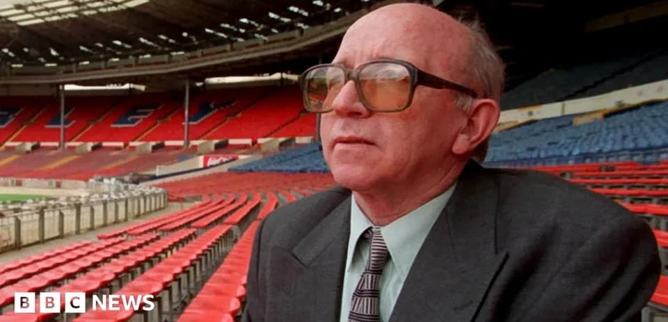 Man sitting in empty stadium stands looking ahead