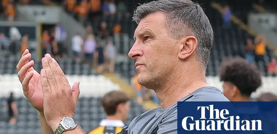 Coach applauding fans in stadium after match