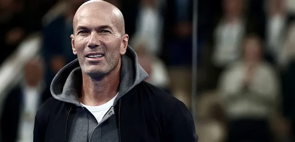 Man smiling during an event with spectators in background