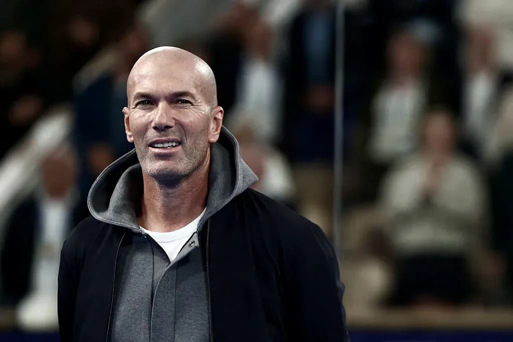 Man smiling during an event with spectators in background