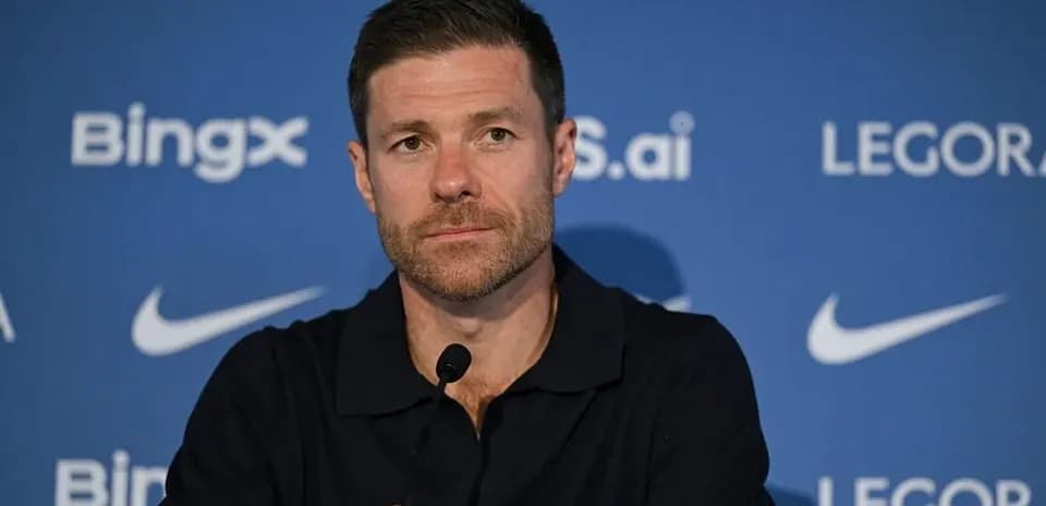 Manager at press conference with branding backdrop