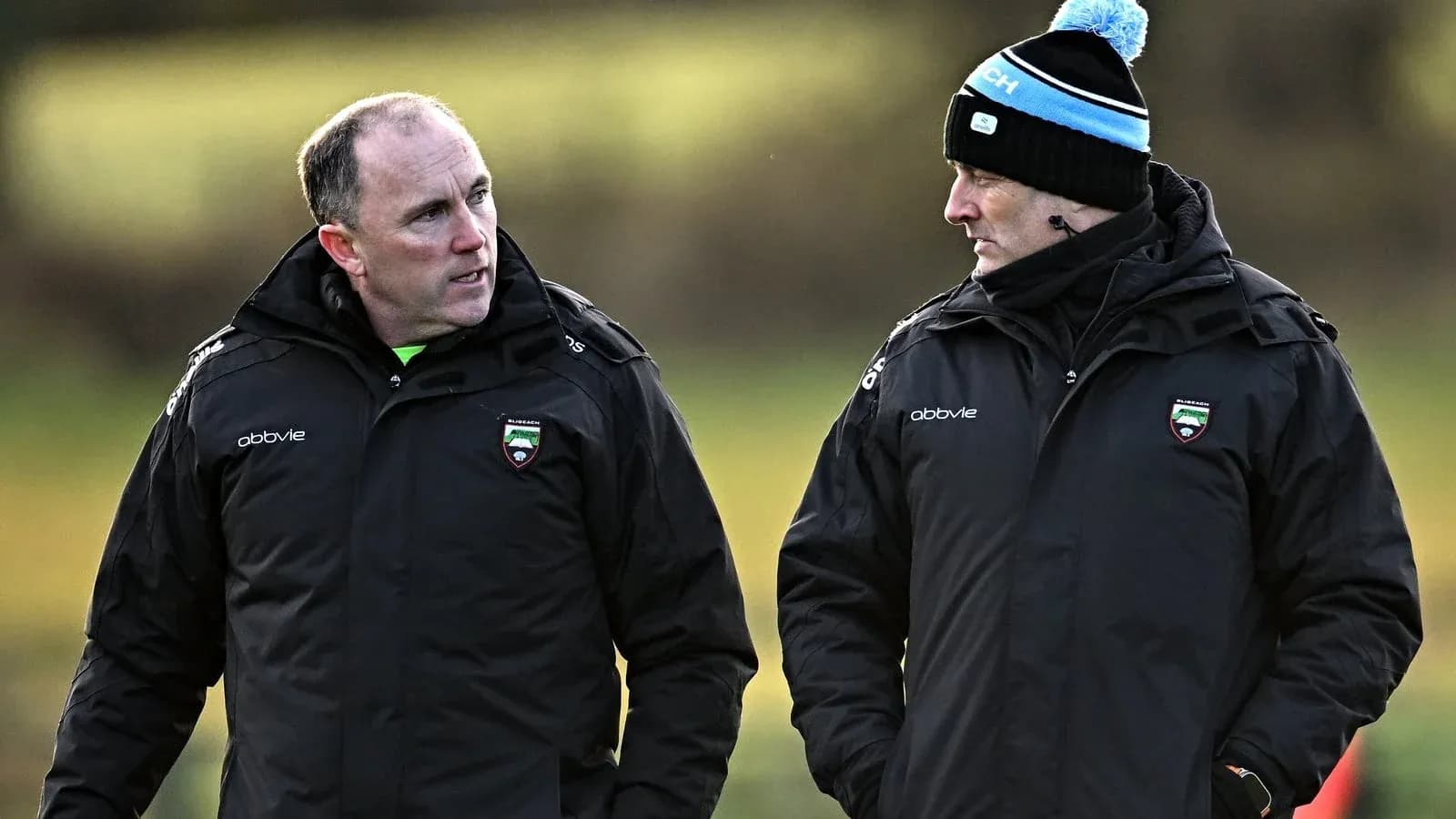 Two coaches discussing strategy during training session