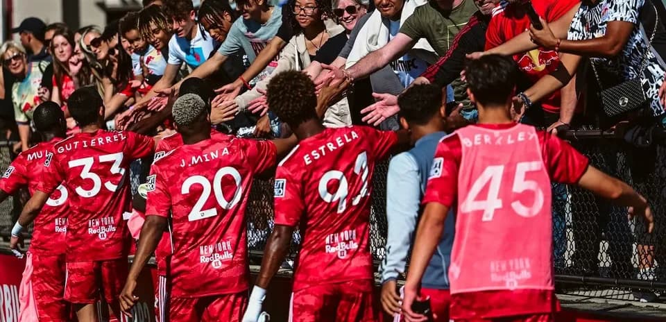 Players interacting with fans after the match