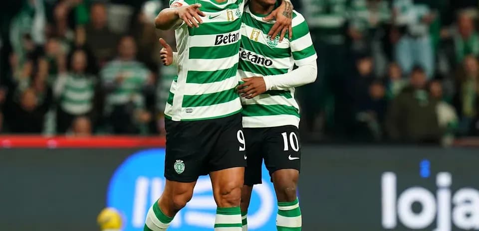 Two players celebrating on the field in jerseys