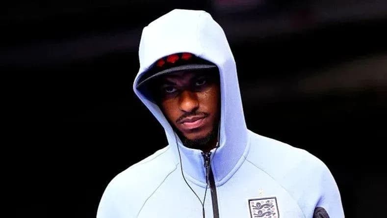 Player wearing hooded jacket entering venue