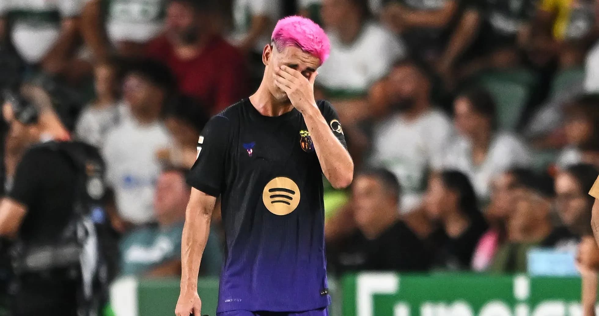 Player with pink hair walking off the field
