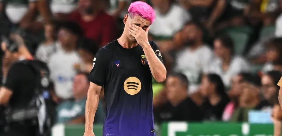 Player with pink hair walking off the field