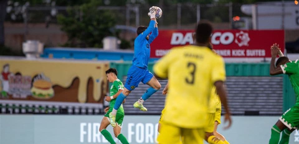 Goalkeeper catching ball during Hartford Athletic match