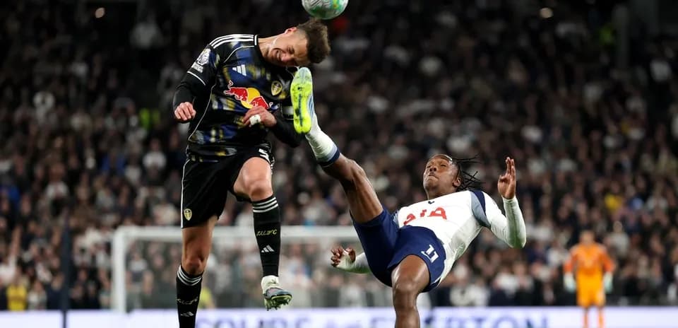 Goalkeeper and player collide during match action