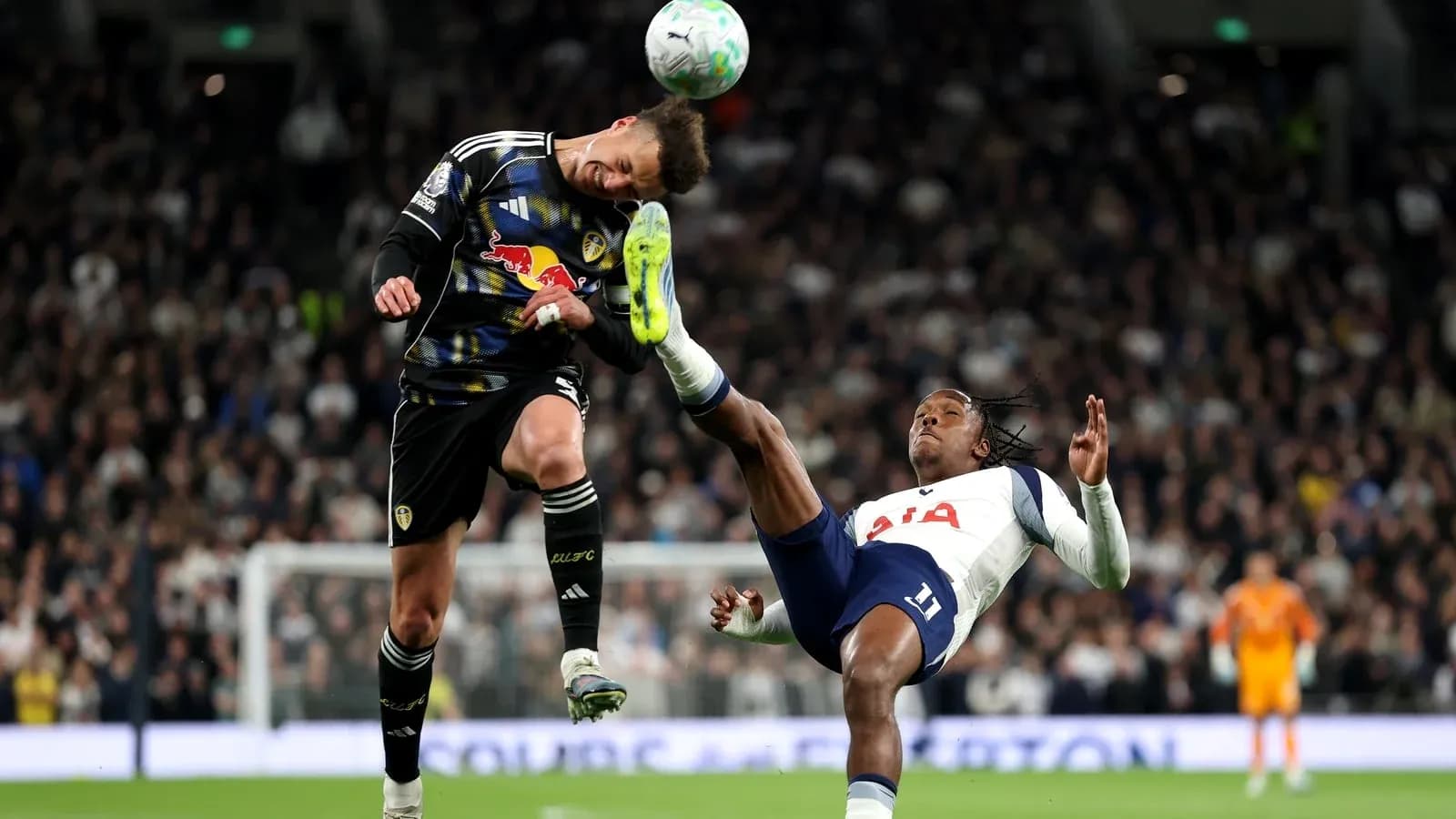 Goalkeeper and player collide during match action