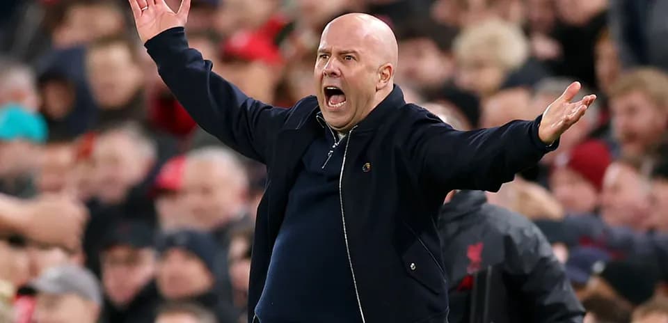 Coach gesturing passionately during match on sidelines