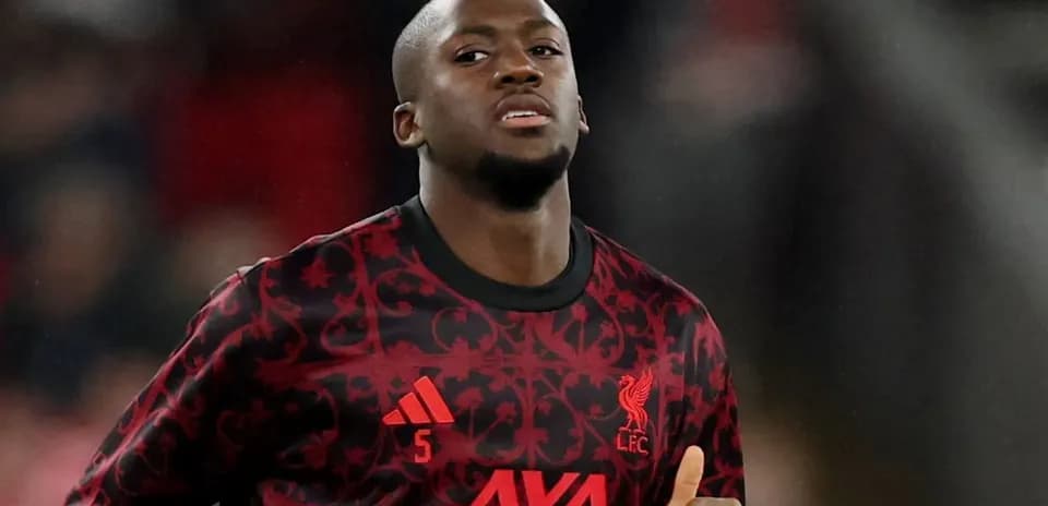 Player wearing Liverpool FC jersey during match warm-up