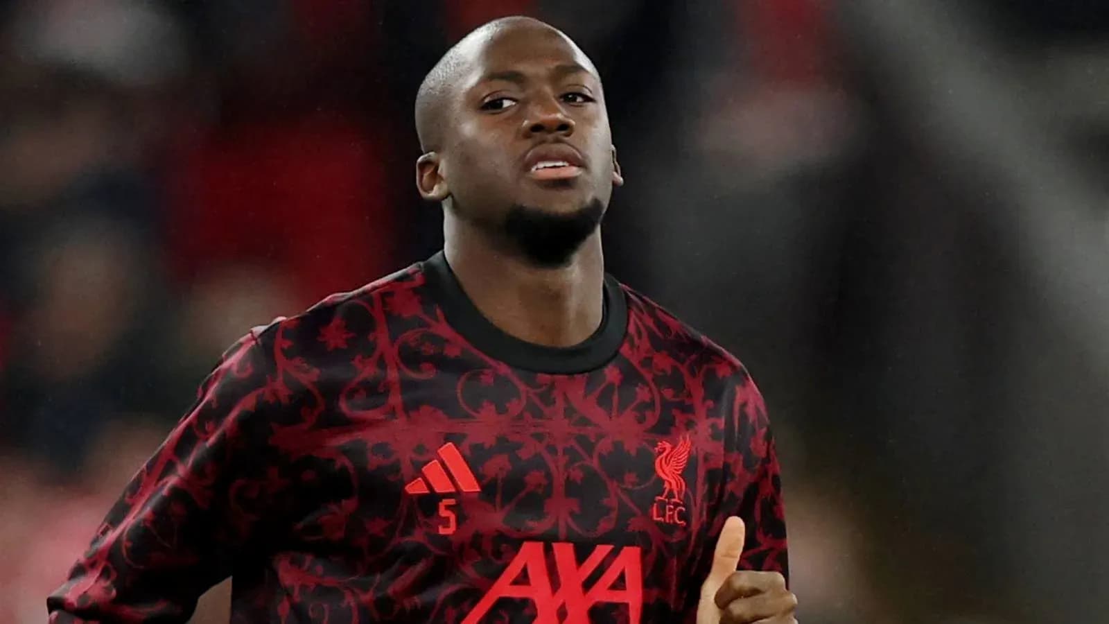 Player wearing Liverpool FC jersey during match warm-up