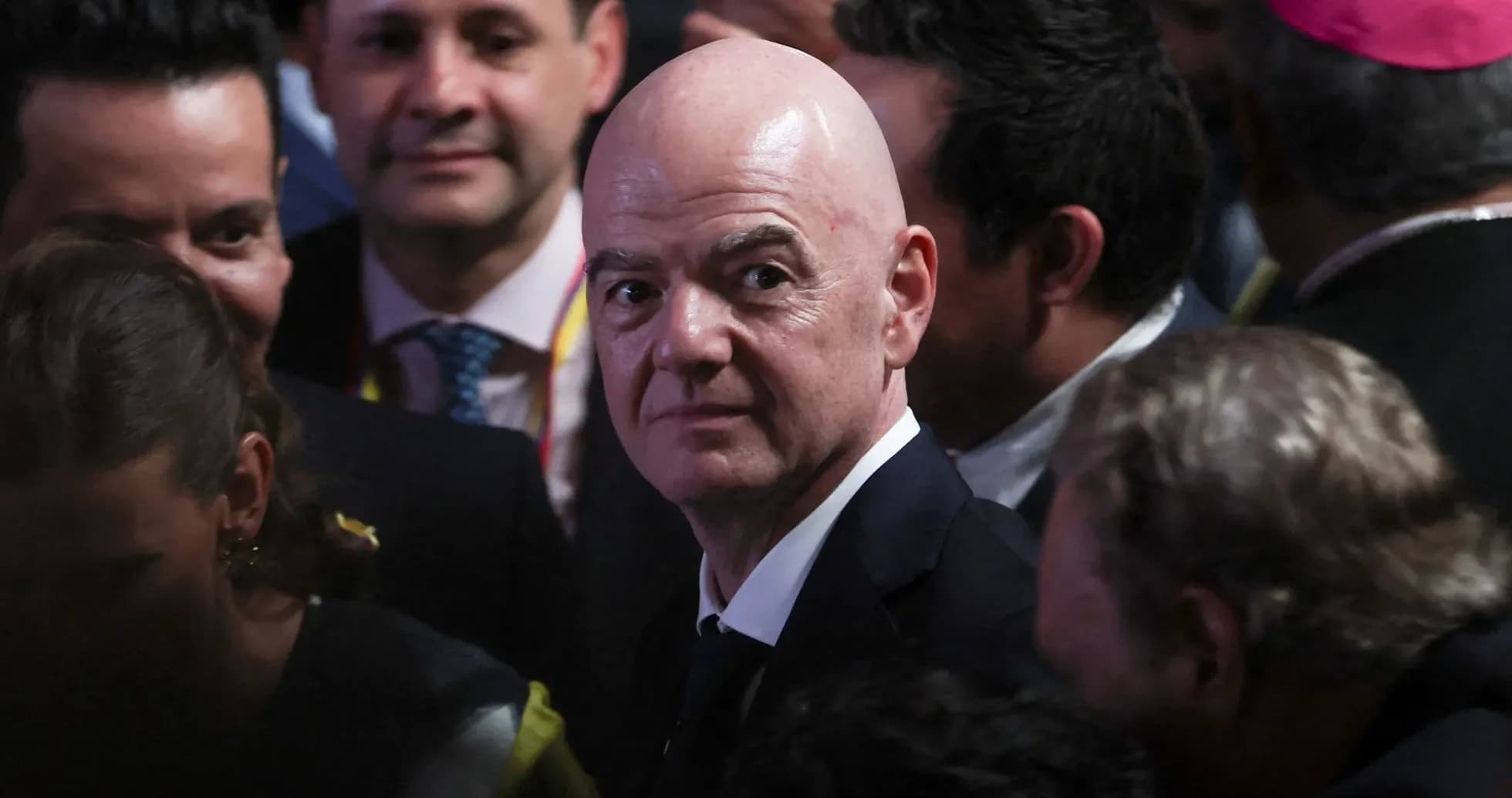 Gianni Infantino surrounded by people at event