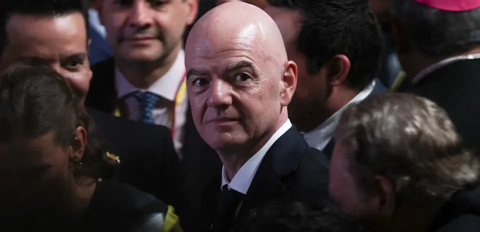Gianni Infantino surrounded by people at event