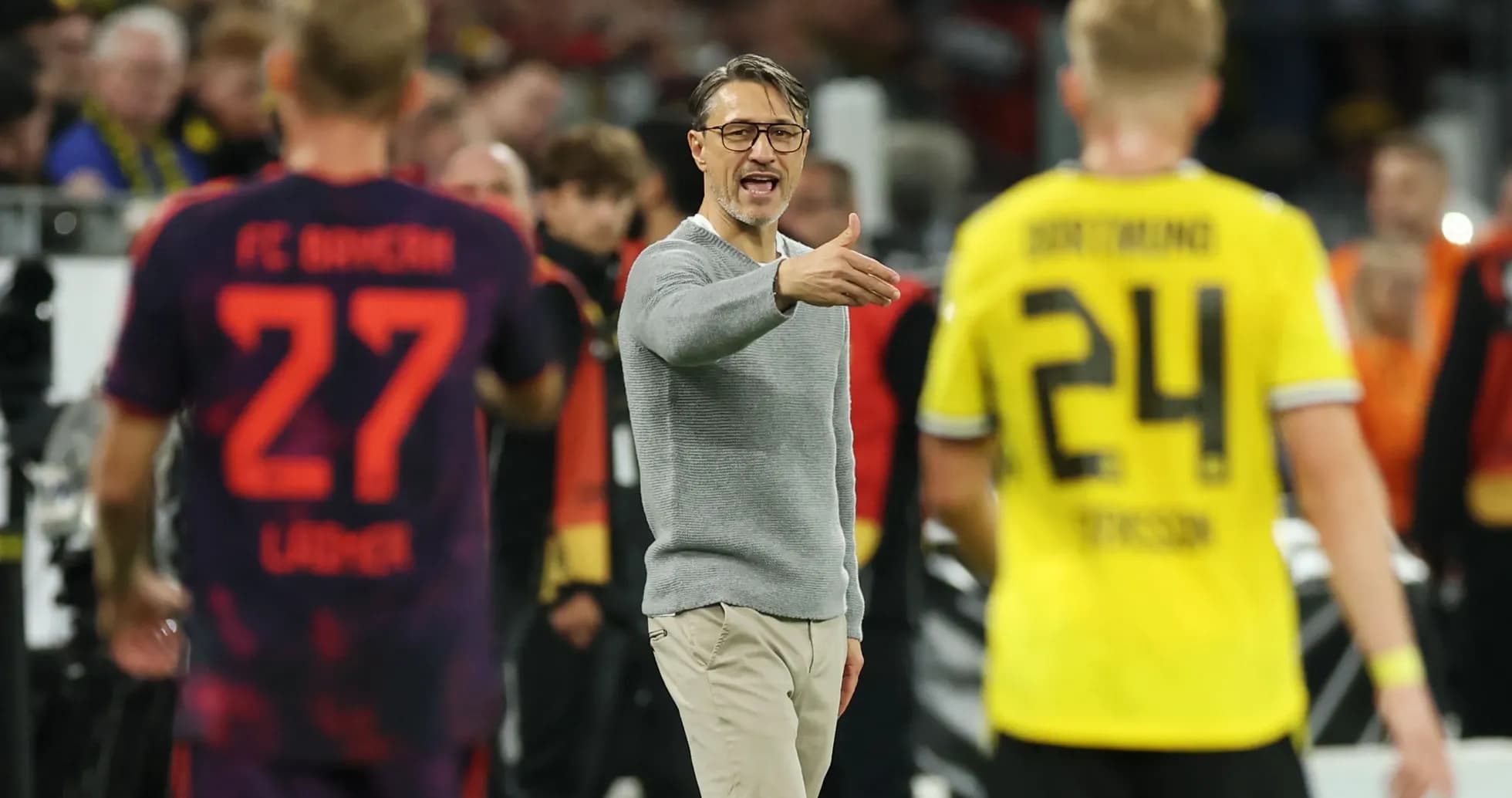 Coach directing players during a Bundesliga match