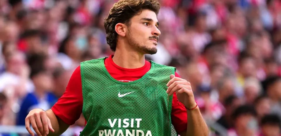 Player in green training bib during match warm-up