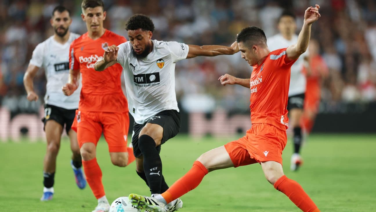 Real Sociedad players challenging Valencia for the ball