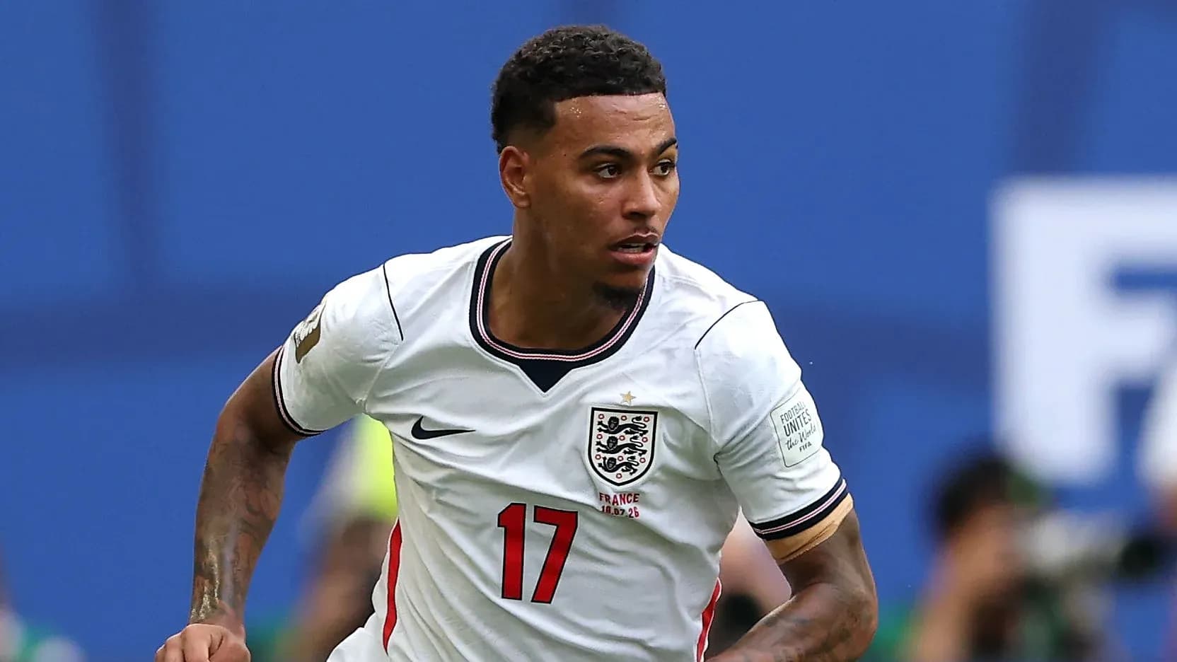 Player in England jersey running on the field