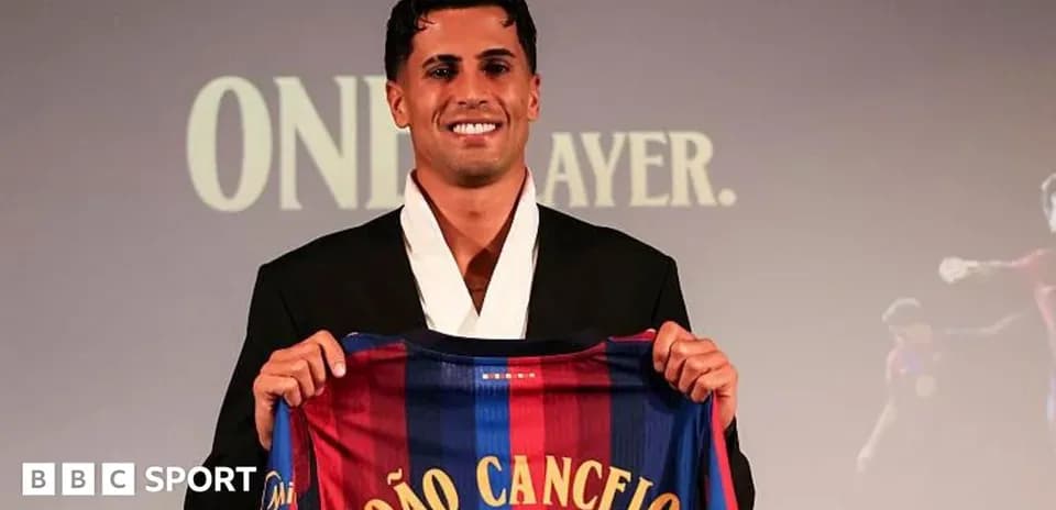 Player holding Barcelona jersey at presentation event